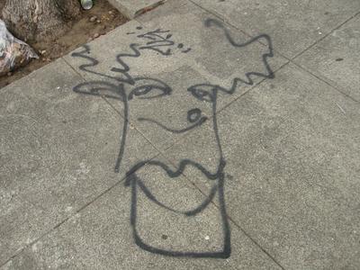Funky head painted on the sidewalk
